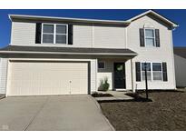 Charming two-story home with attached garage and welcoming front entrance and black shutters at 2434 Orchard Creek Dr, Columbus, IN 47201
