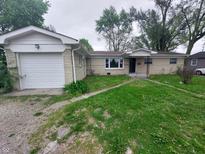 Charming single-story home features an attached garage and a well-maintained front yard at 2741 N Keystone Ave, Indianapolis, IN 46218
