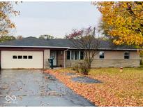 Charming single story home with attached garage and stone accents amid colorful fall foliage at 3186 S Avon Ave, Plainfield, IN 46168