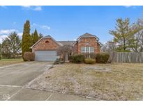 Charming brick home with a well-maintained front yard and attached two-car garage at 7024 Ringtail Ct, Indianapolis, IN 46254