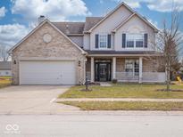 Charming two-story home with a brick facade, attached two-car garage, and inviting covered porch at 7625 Corsican Cir, Avon, IN 46123