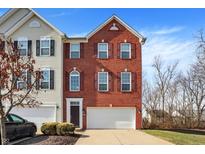 Charming two-story brick home with an attached garage and neatly maintained landscaping at 9352 Tanhurst Dr, Indianapolis, IN 46250