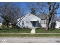 Charming single Gathering home with a manicured lawn and a detached one car garage with mature trees at 1050 Allison Ave, Speedway, IN 46224