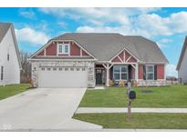 Charming home featuring a two-car garage, nicely manicured lawn, and stylish architectural details at 1051 Macoun Dr, Westfield, IN 46074