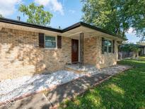 Charming brick home with a well-maintained lawn and inviting front entrance at 1202 E Stop 10 Rd, Indianapolis, IN 46227