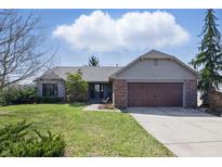 Charming ranch home featuring a brick facade, well-manicured lawn, and an attached two-car garage at 12205 Whitebark Dr, Indianapolis, IN 46236