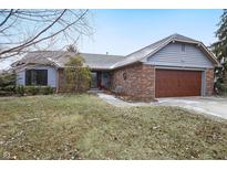 Charming single-story home with brick and siding exterior, attached garage, and a well-maintained front yard at 12205 Whitebark Dr, Indianapolis, IN 46236