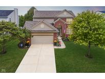 Charming two-story home featuring a well-manicured lawn and attached two-car garage at 12770 Bristow Ln, Fishers, IN 46037