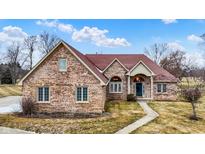 Charming single-Gathering home featuring a brick exterior, well-manicured lawn, and inviting entrance at 2566 E Fairway Village Dr, Greenfield, IN 46140