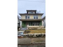 Exterior of a two-story home with a covered front porch and yard, showcasing its potential at 3543 N Kenwood Ave, Indianapolis, IN 46208
