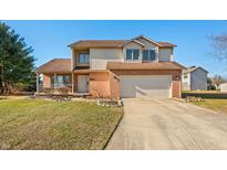 Charming two-story home with a two-car garage and well-maintained front yard at 3605 Greenway Ct, Columbus, IN 47203