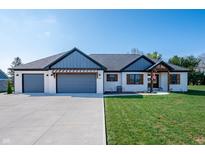 Charming home featuring a three-car garage, manicured lawn, and inviting exterior at 413 Cardinal Dr, Jamestown, IN 46147