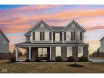 Charming two-story home with brick and siding exterior, covered porch, and manicured landscaping at 6546 W Dickens Xing, McCordsville, IN 46055