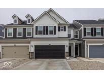 Charming two-story home featuring a black garage door, white siding, and black shutters at 658 Axford Bay Dr, Westfield, IN 46074