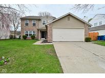 Charming two-story home with a brick and vinyl facade, complemented by a well-maintained lawn and an attached two-car garage at 9685 Glowing Flame Dr, Fishers, IN 46037