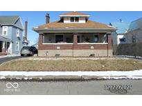 Charming two-story home with a brick foundation and inviting front porch, awaiting personal touches at 1524 S K St, Elwood, IN 46036