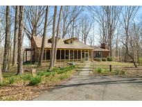 Charming home with a welcoming, covered porch and blooming spring flowers along the walkway at 1828 W 750 S, Trafalgar, IN 46181