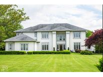 Stunning two-story home features large windows, a manicured lawn, and lush landscaping at 4103 Golden Grove Rd, Greenwood, IN 46143