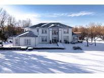 Stunning two-story home featuring a symmetrical design and snow-covered front yard at 4103 Golden Grove Rd, Greenwood, IN 46143