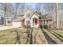 Charming two-story home featuring a red front door and brick and siding exterior at 4947 Cherryhill Ct, Indianapolis, IN 46254