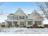 Charming two-story home featuring a manicured lawn and classic architectural details at 5528 Cottage Grove Ln, Noblesville, IN 46062