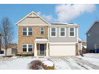Charming two-story brick home featuring an attached garage and a well-maintained front yard, perfect for a growing Gathering at 6354 Fawn Way, McCordsville, IN 46055