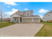 Charming two-story home with a three-car garage and inviting front porch on a sunny day at 6705 Park Grove Blvd, Whitestown, IN 46075