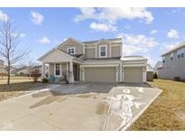 Inviting two-story home with attached two car garage, covered porch and well-kept landscaping at 6705 Park Grove Blvd, Whitestown, IN 46075