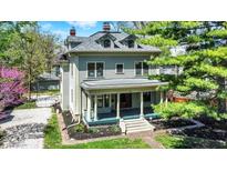 Charming two-story home with a welcoming front porch and well-maintained landscaping at 828 Woodruff Place Middle Dr, Indianapolis, IN 46201