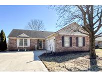Charming single-story home with brick facade, well-maintained lawn, and inviting curb appeal on a sunny day at 9667 Overcrest Dr, Fishers, IN 46037