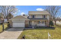 Charming two-story home featuring stone accents, a two-car garage, and a well-manicured front yard at 101 Aspen Way, Noblesville, IN 46062