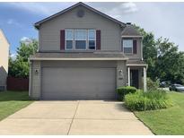 Charming two-story home featuring a two-car garage and well-maintained landscaping, perfect for Gathering living at 10419 Dark Star Dr, Indianapolis, IN 46234
