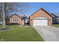 Charming brick home with a well-manicured lawn and a two-car garage, perfect for suburban living at 10944 Haig Point Dr, Fishers, IN 46037