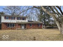 Charming two-story brick home featuring red shutters and a welcoming front entrance at 11506 Rolling Springs Dr, Carmel, IN 46033