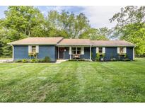 Charming single story home with blue brick, complemented by a lush green lawn and beautiful landscaping at 11710 Prairie Pl, Carmel, IN 46033