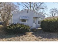 Charming single-story home featuring light blue siding and well-maintained front yard landscaping at 1427 S Kiel Ave, Indianapolis, IN 46241
