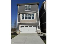 Charming two-story home featuring a white garage door, complementary gray siding, and ample natural light at 15407 Mystic Rock Dr, Carmel, IN 46033