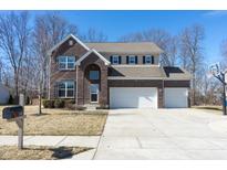 Charming two-story brick home with a spacious driveway and well-manicured lawn at 1566 Dorset Dr, Avon, IN 46123