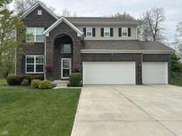 Charming two-story brick home features a spacious driveway and attached two-car garage at 1566 Dorset Dr, Avon, IN 46123