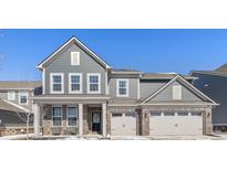 Charming two-story home with a two-car garage, beautiful brick accents, and a welcoming front porch at 16052 Sedalia Dr, Fishers, IN 46040