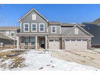 Charming two-story home with a three-car garage, brick accents, and a covered porch in a quiet neighborhood at 16052 Sedalia Dr, Fishers, IN 46040