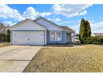 Charming home featuring a well-maintained lawn, attached garage, and inviting curb appeal at 19215 Calico Aster Dr, Noblesville, IN 46062