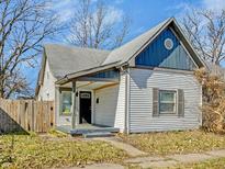 Charming two-story home featuring a cozy front porch, traditional siding, and a neatly maintained yard at 2014 Barth Ave, Indianapolis, IN 46203