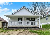 Charming single-story home with a covered front porch, white siding, and a well-maintained yard at 2137 Napoleon St, Indianapolis, IN 46203