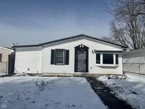 Charming one story house with a secure front door and clean white siding at 2306 Finley Ave, Indianapolis, IN 46203