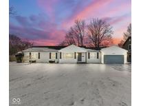 Charming single-story home with attached garage and snow-covered front yard and a beautiful twilight sky at 2901 W 11Th St, Anderson, IN 46011