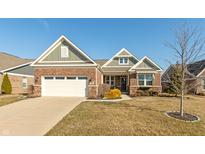 Charming brick home featuring attached garage, manicured landscaping, and inviting curb appeal at 3982 Abbotsford Dr, Westfield, IN 46074