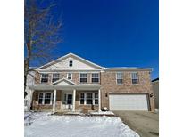 Charming brick two-story home featuring a classic design, covered front porch, and two-car garage at 417 Legacy Blvd, Greenwood, IN 46143