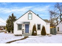 Charming home featuring a white facade, tidy landscaping and a blue front door at 5502 Rawles Ter, Indianapolis, IN 46219
