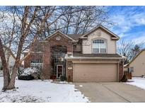 Charming two-story brick home with a two-car garage in a suburban neighborhood at 602 Burr Oak Dr, Carmel, IN 46032